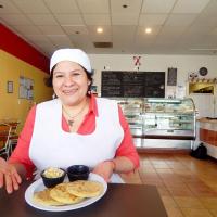 Xinia's Bakery, Xinia Cruz, owner with pupusas